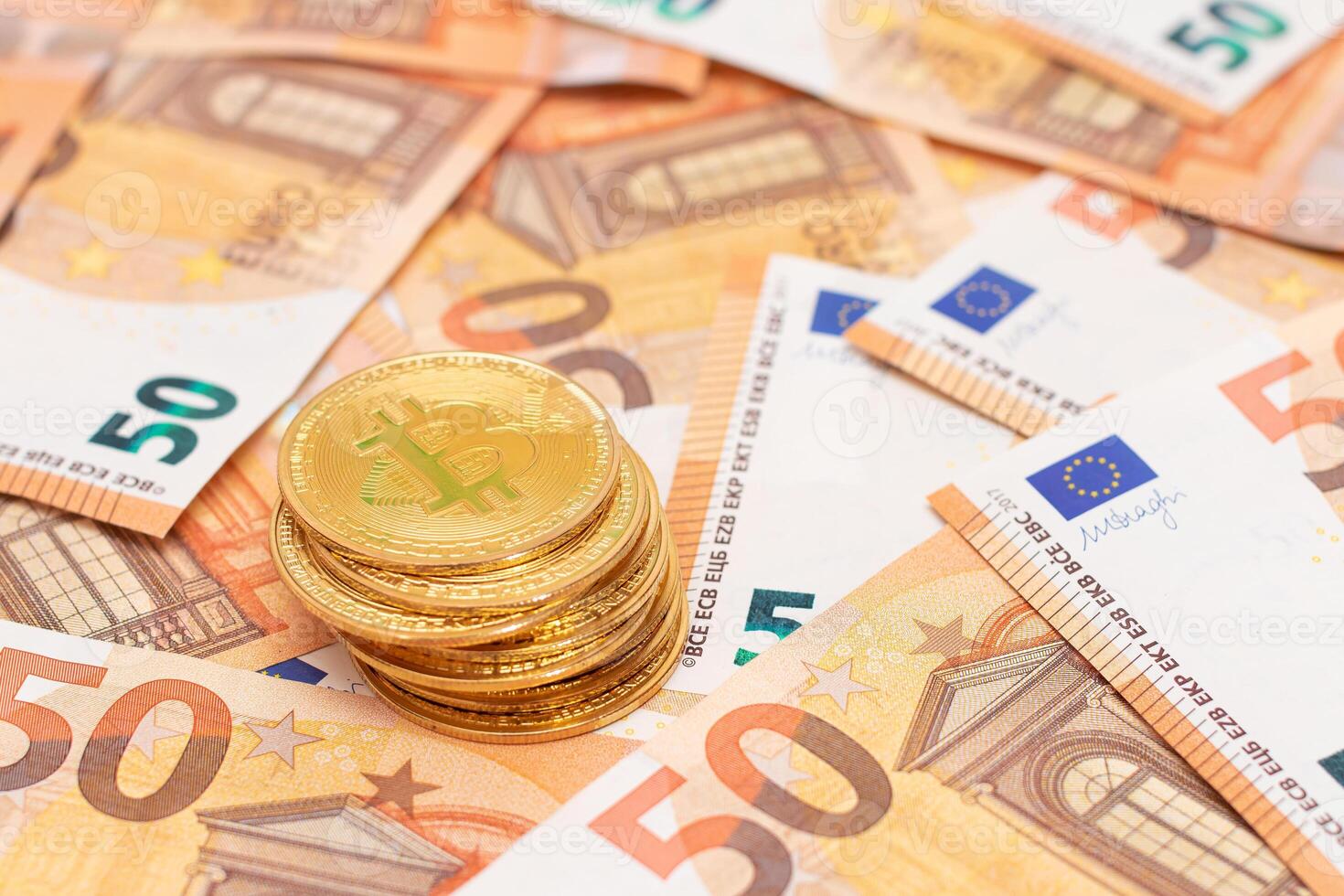 A Stack of Bitcoin Coins on the 50 Euro Banknotes. Euro Currency and Crypto Currency. Orange Paper Money. A Lot of Fifty-Euro Bills. Finances, Cash, Anonymous Payments and Money Saving Concept photo