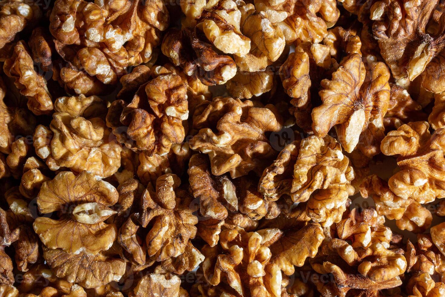 Scattered Shelled Walnuts. Background from Walnut. Natural High-Calorie Snacks photo
