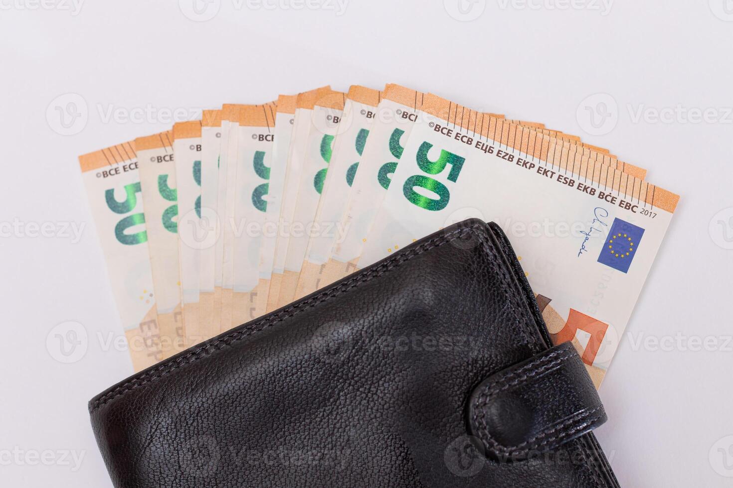 Black Leather Men Wallet with Fifty Euro Banknotes Inside - on White Background. A Purse Full of Money Symbolizing Wealth, Success and Social Status - Isolation photo