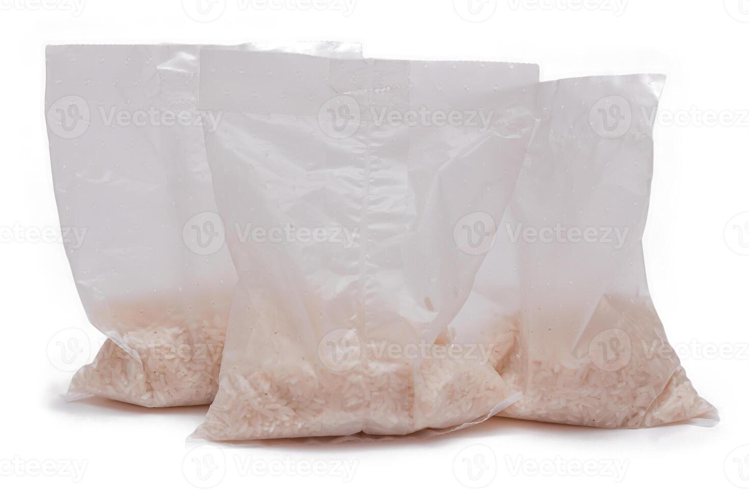 A Plastic Bags of White Long Grain Rice - Isolated on White Background. Small Transparent Packages with Dry Rice - Isolation photo