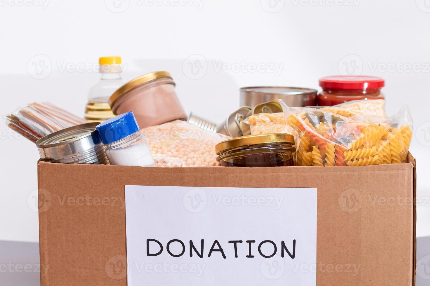Donation Box of Free Food. Carton Box with Canned Food, Cereals and Grocery. Meal Reserves. Emergency Food Storage in Case of Crisis. Free Social Help, Blessings and Care. Strategic Food Supplies photo