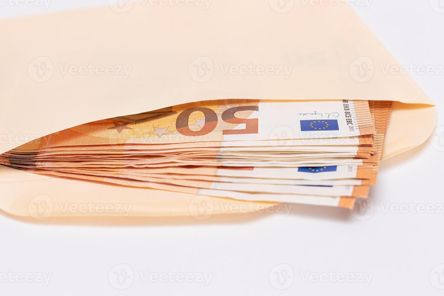 An Orange Paper Envelope with Stack of 50-Euro Banknotes Inside. Salary in Cash. Tax-Free System. Euro Currency. Payments with No Taxes. Orange Paper Money. A Lot of Fifty-Euro Bills photo