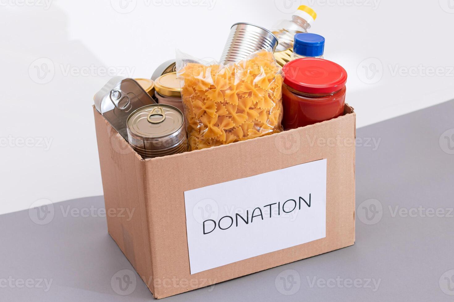 Donation Box of Free Food. Carton Box with Canned Food, Cereals and Grocery. Meal Reserves. Emergency Food Storage in Case of Crisis. Free Social Help, Blessings and Care. Strategic Food Supplies photo