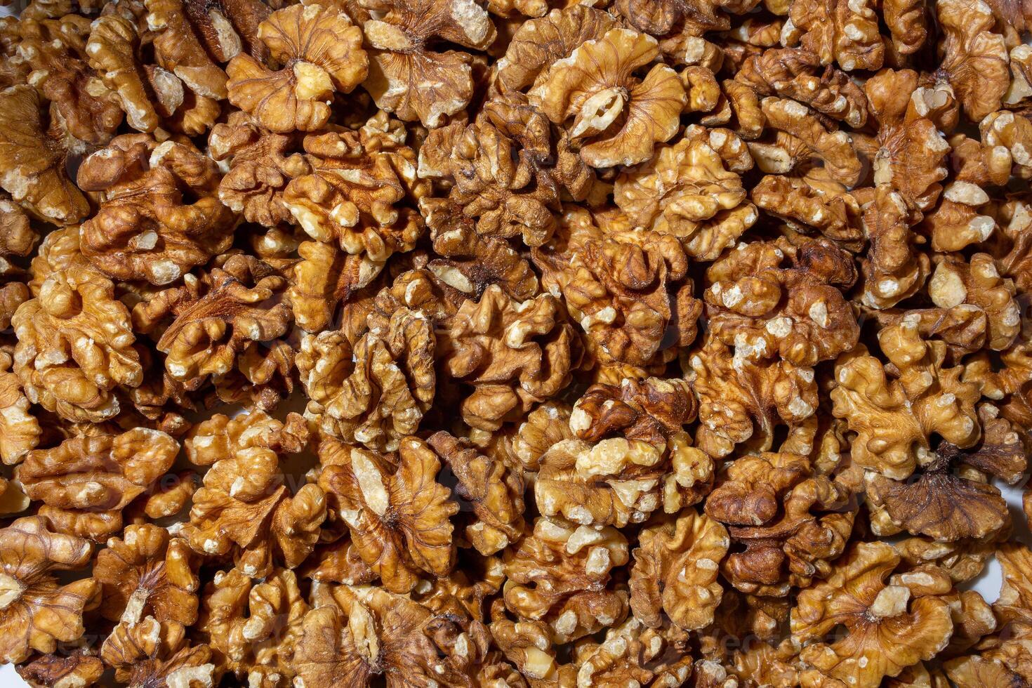 Scattered Shelled Walnuts. Background from Walnut. Natural High-Calorie Snacks photo