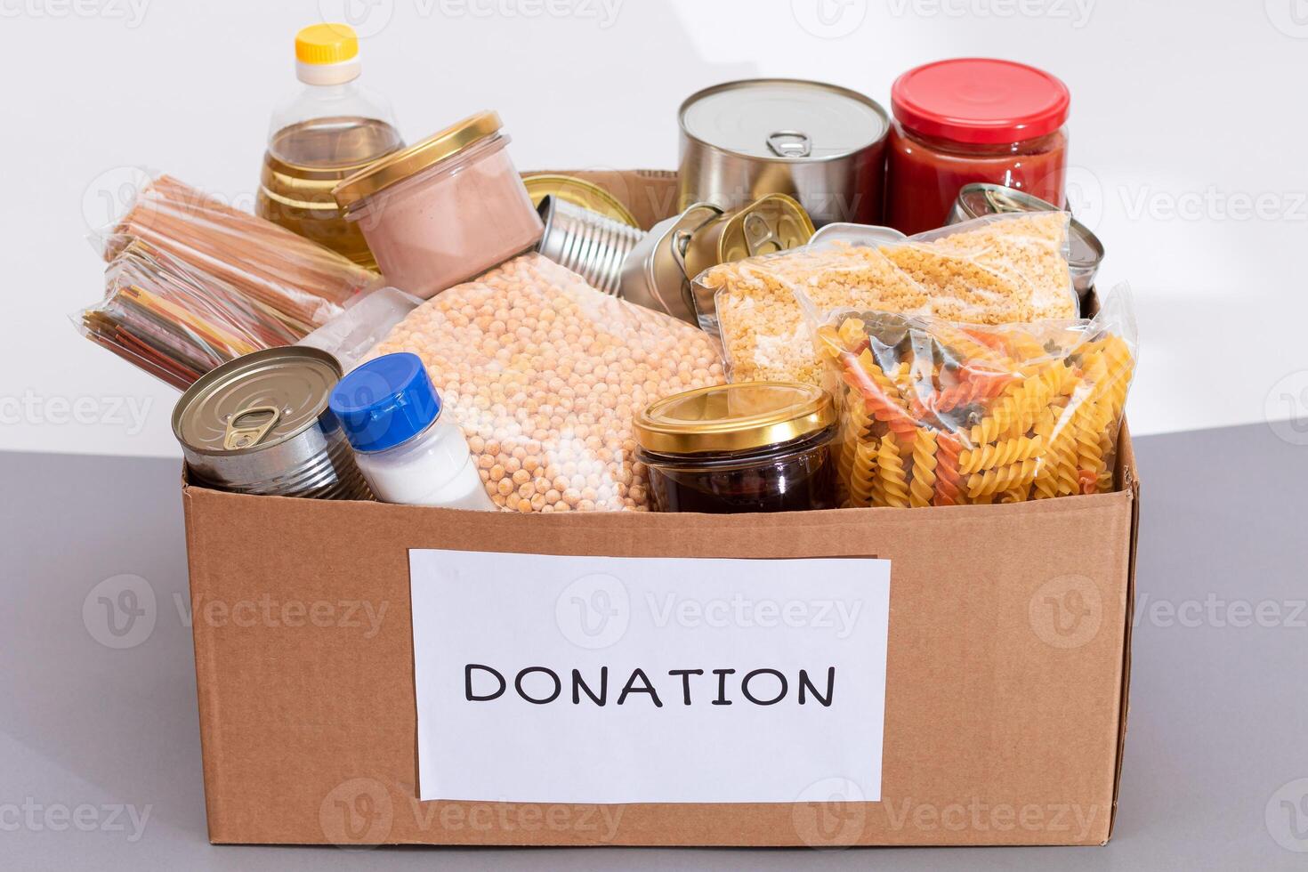 Donation Box of Free Food. Carton Box with Canned Food, Cereals and Grocery. Meal Reserves. Emergency Food Storage in Case of Crisis. Free Social Help, Blessings and Care. Strategic Food Supplies photo