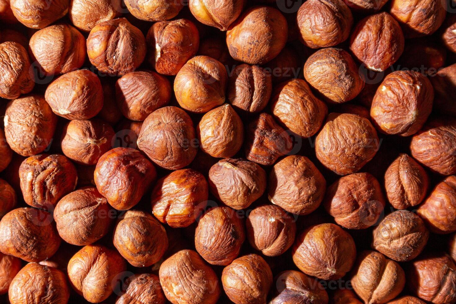 Scattered Peeled Hazelnut - Top View. Background from Hazelnuts. Natural High-Calorie Snacks photo