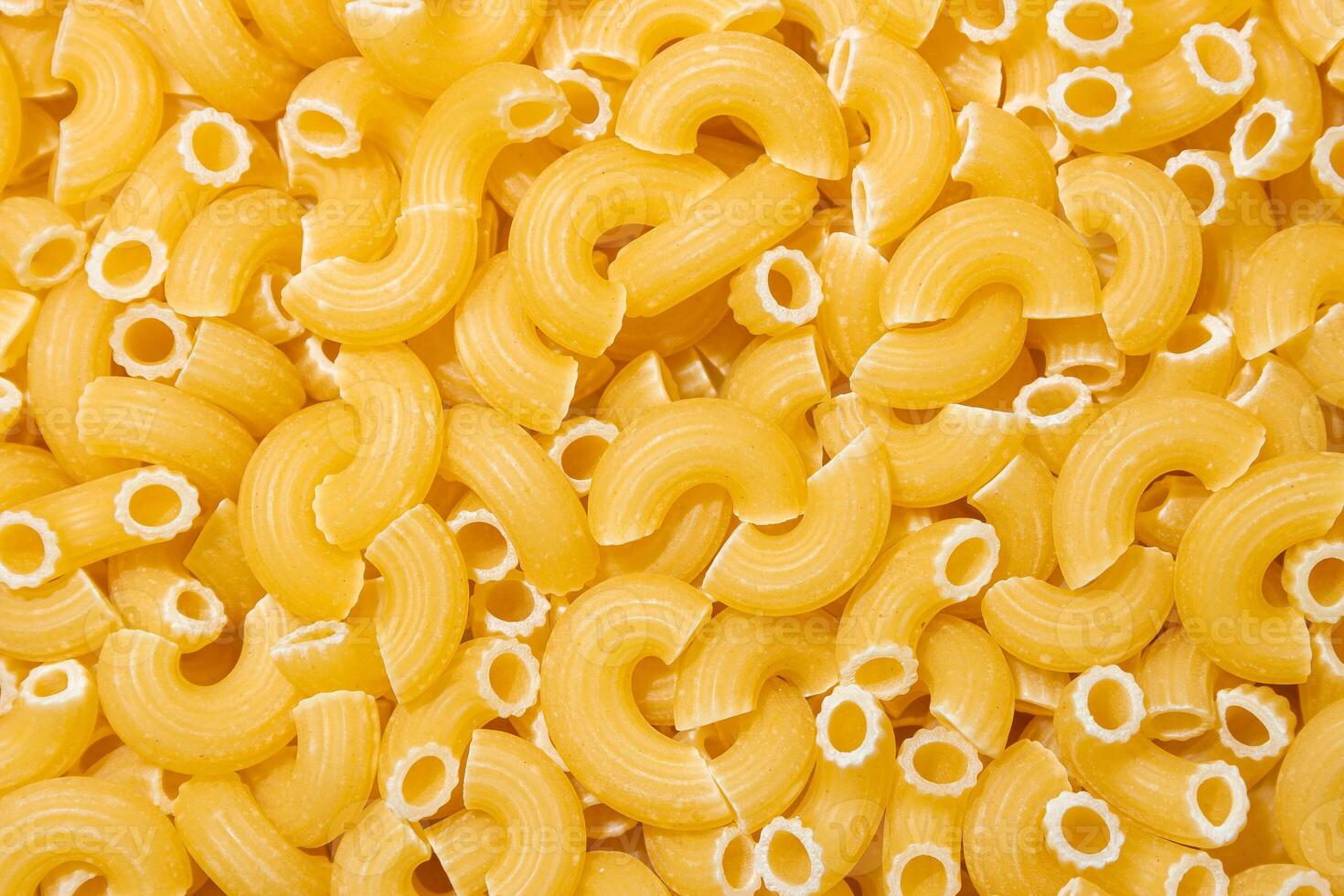 Uncooked Chifferi Rigati Pasta. A Culinary Canvas of Chifferi Rigati, Creating a Lively and Textured Background for Gourmet Cooking. Dry Pasta. Raw Macaroni - Top View, Flat Lay photo