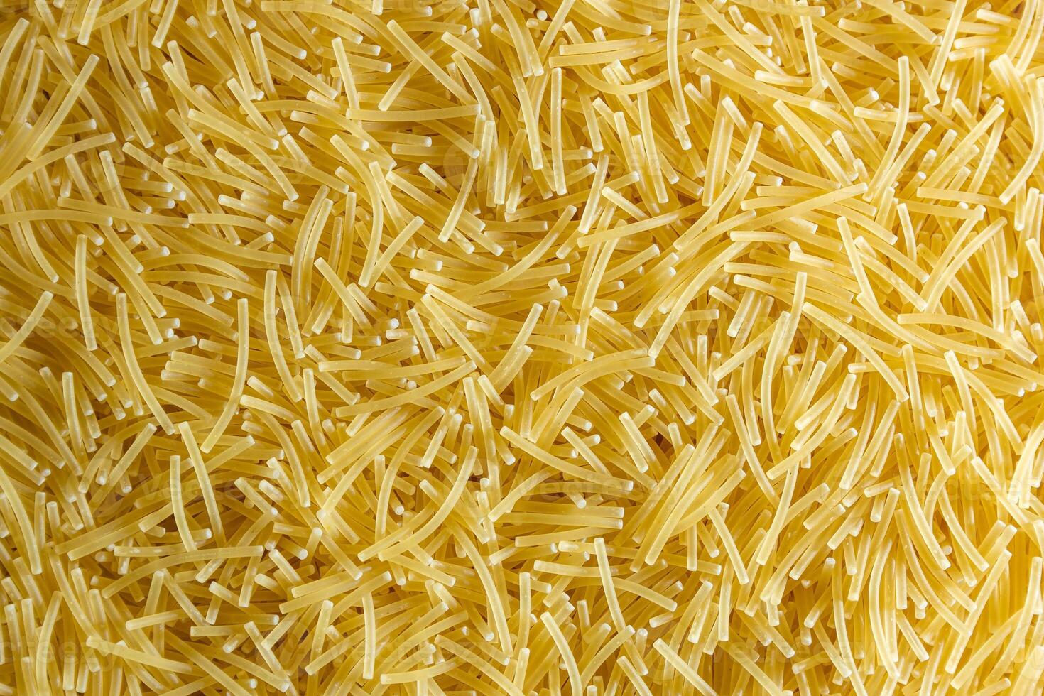 Uncooked Filini Pasta. A Culinary Canvas of Noodles, Creating a Lively and Textured Background for Gourmet Cooking. Dry Pasta. Raw Macaroni - Top View, Flat Lay photo