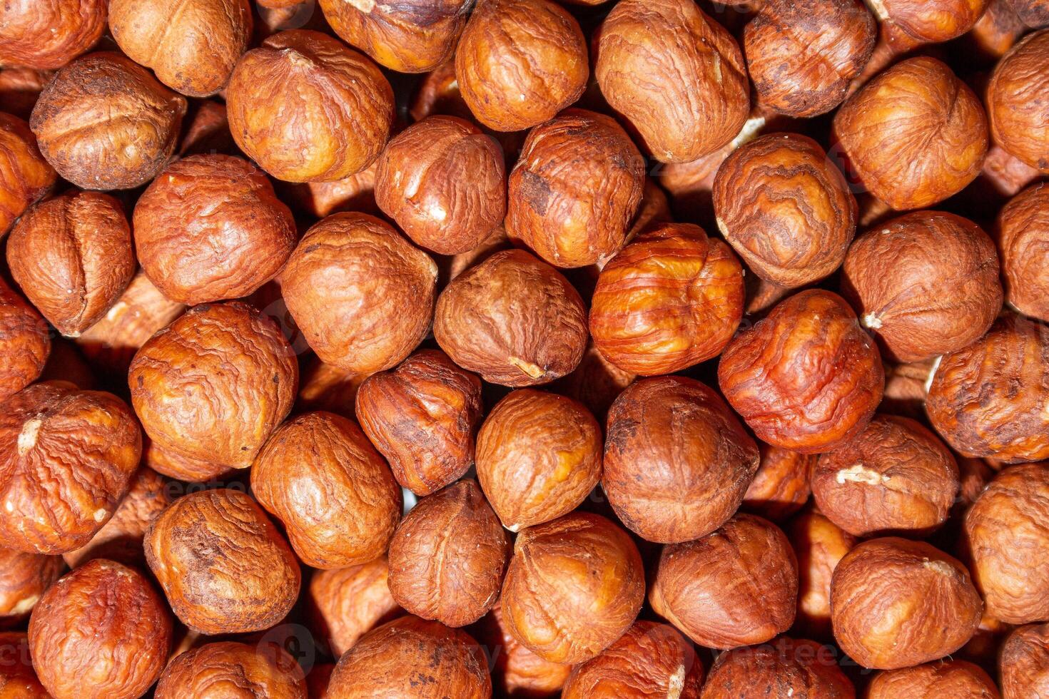 Scattered Peeled Hazelnut - Top View. Background from Hazelnuts. Natural High-Calorie Snacks photo