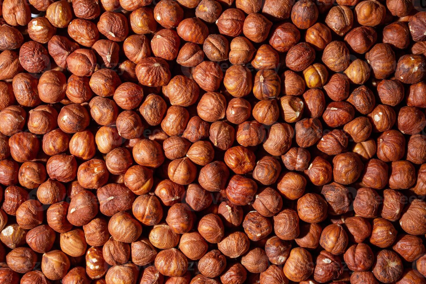 Scattered Peeled Hazelnut - Top View. Background from Hazelnuts. Natural High-Calorie Snacks photo