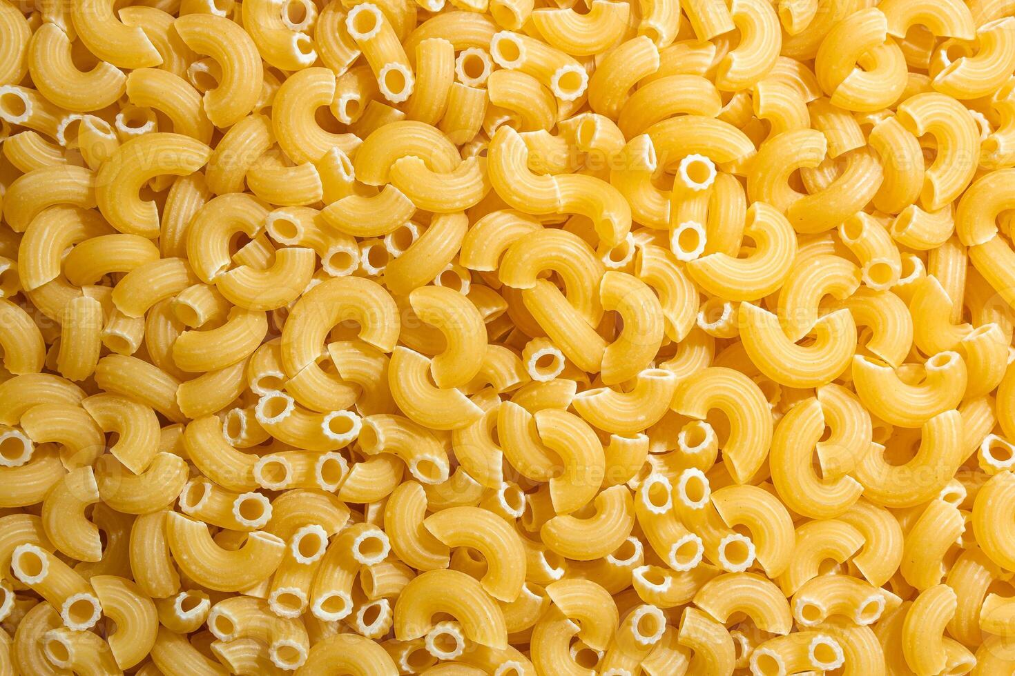 Uncooked Chifferi Rigati Pasta. A Culinary Canvas of Chifferi Rigati, Creating a Lively and Textured Background for Gourmet Cooking. Dry Pasta. Raw Macaroni - Top View, Flat Lay photo