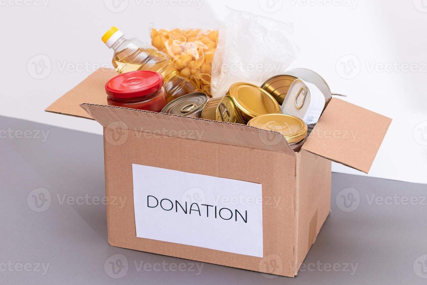 Donation Box of Free Food. Carton Box with Canned Food, Cereals and Grocery. Meal Reserves. Emergency Food Storage in Case of Crisis. Free Social Help, Blessings and Care. Strategic Food Supplies photo