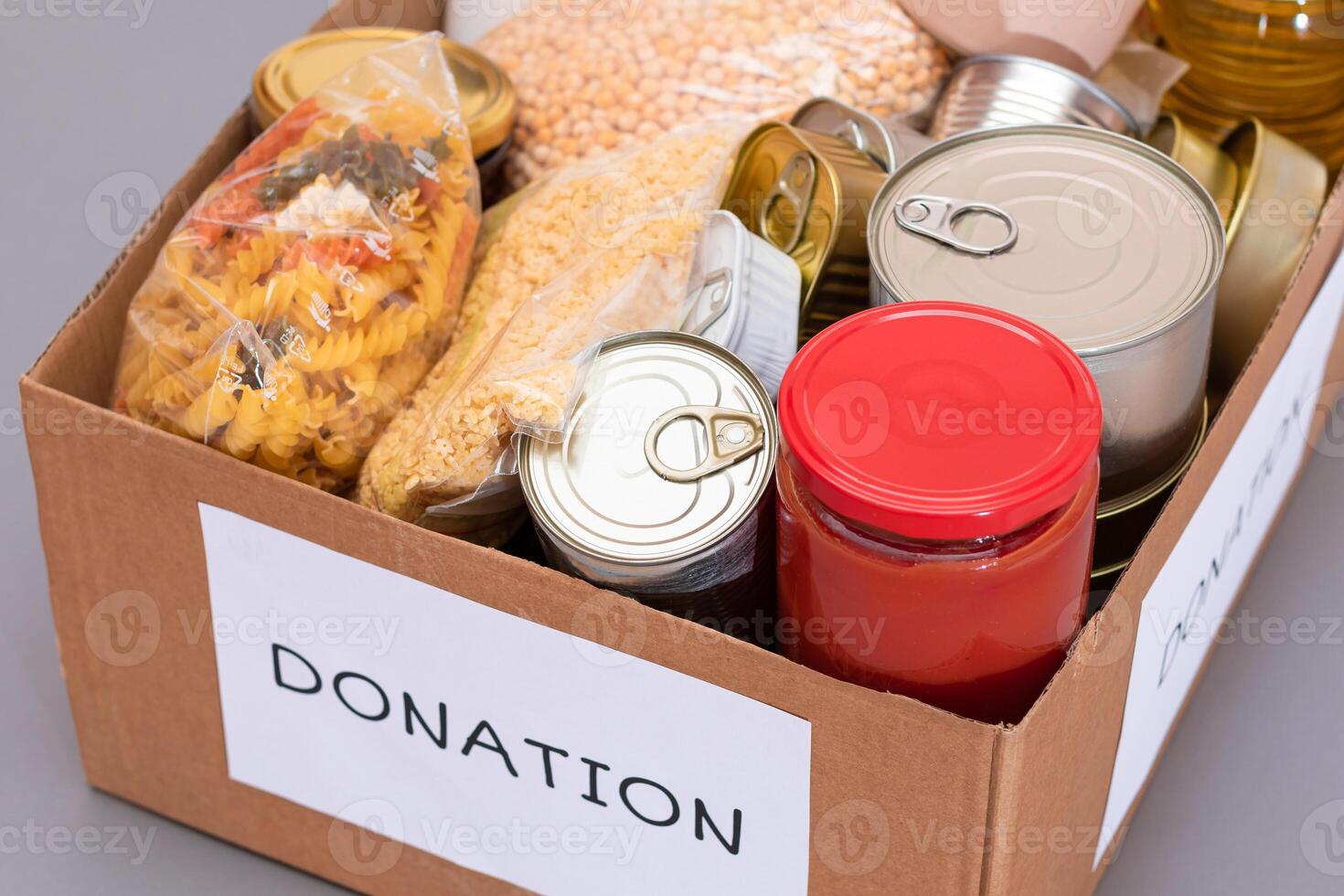 Donation Box of Free Food. Carton Box with Canned Food, Cereals and Grocery. Meal Reserves. Emergency Food Storage in Case of Crisis. Free Social Help, Blessings and Care. Strategic Food Supplies photo
