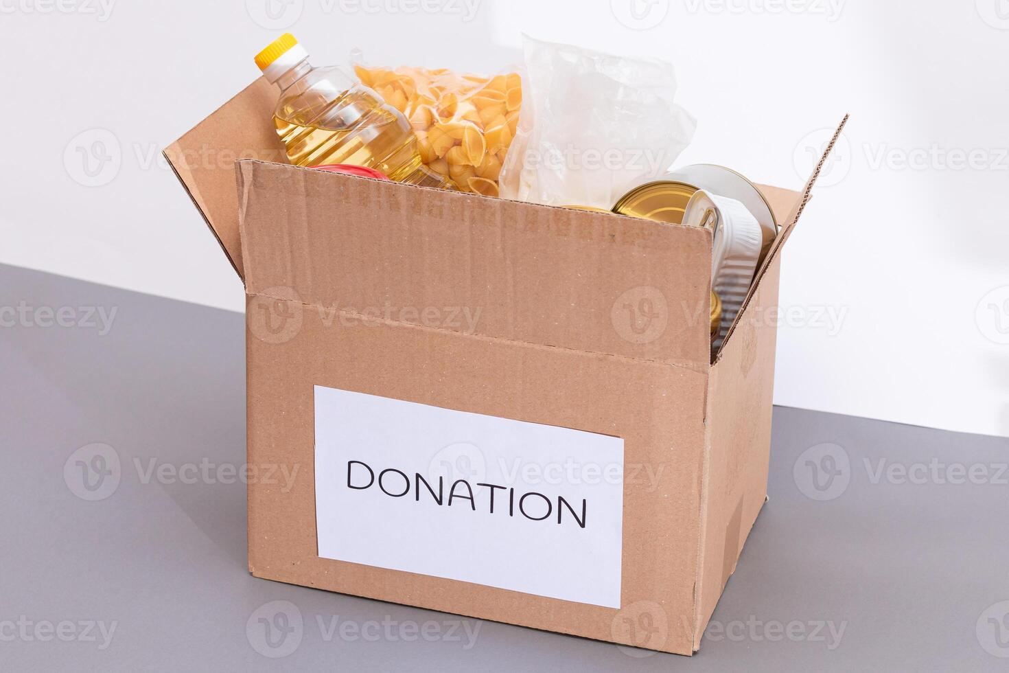 Donation Box of Free Food. Carton Box with Canned Food, Cereals and Grocery. Meal Reserves. Emergency Food Storage in Case of Crisis. Free Social Help, Blessings and Care. Strategic Food Supplies photo
