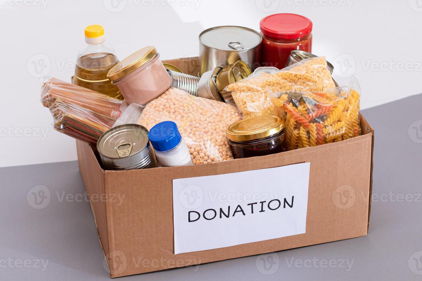 Donation Box of Free Food. Carton Box with Canned Food, Cereals and Grocery. Meal Reserves. Emergency Food Storage in Case of Crisis. Free Social Help, Blessings and Care. Strategic Food Supplies photo