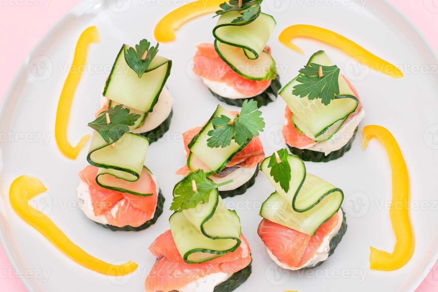 Canapes without Bread with Fresh Salmon, Cucumber and Cream Cheese on White Plate. Easy Breakfast. Diet Food. Quick and Healthy Sandwiches. Healthy Snacks with Tasty Fillings photo