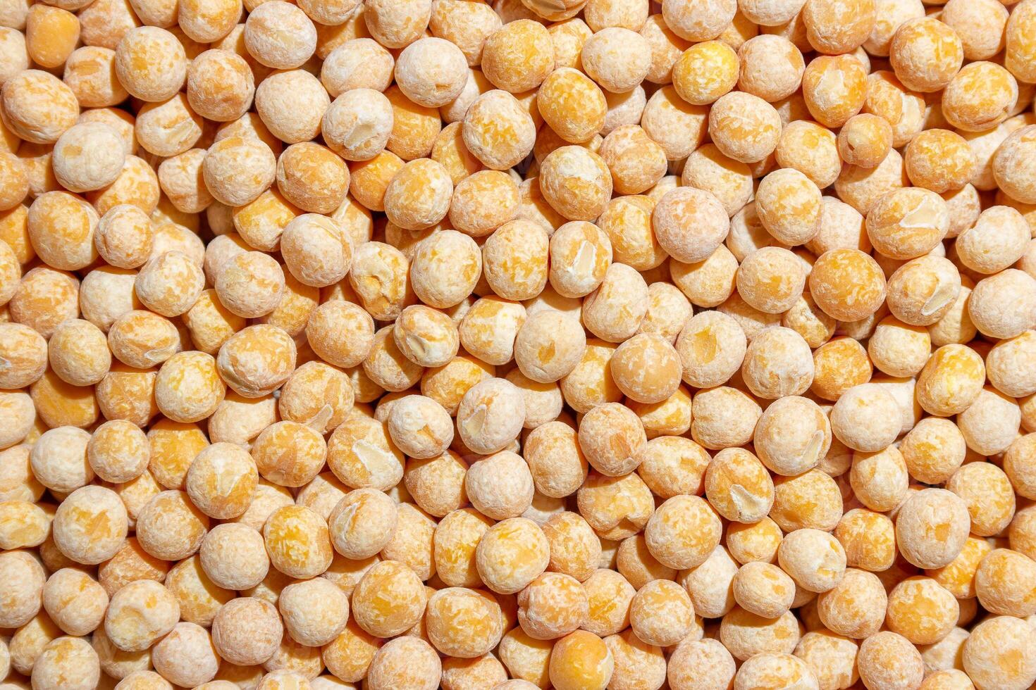 Uncooked Yellow Polished Peas Background. A Culinary Canvas of Dry Yellow Peas, Creating a Lively and Textured Background for Gourmet Cooking. Scattered Raw Polished Peas. Healthy Eating Ingredients photo