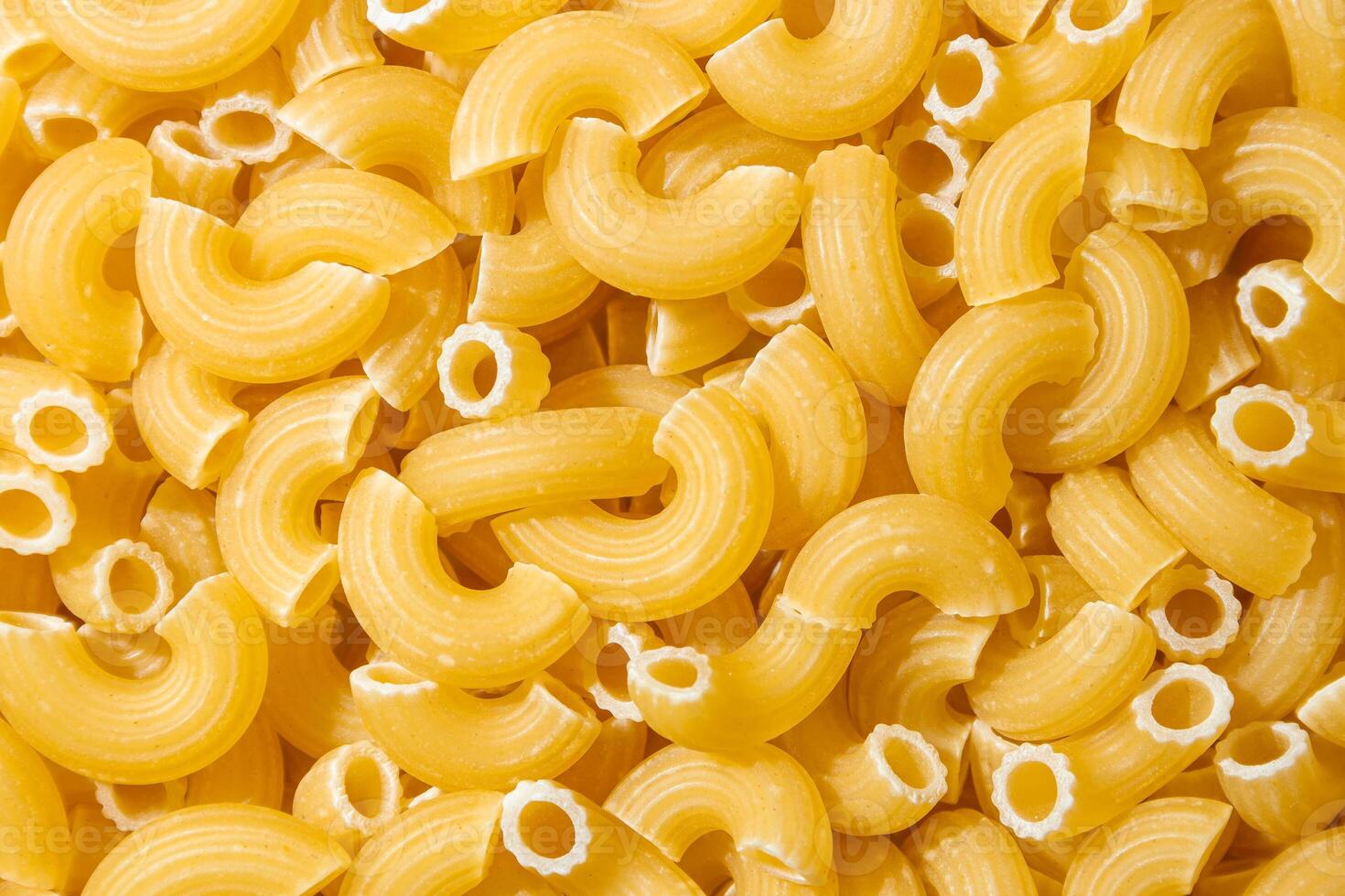 Uncooked Chifferi Rigati Pasta. A Culinary Canvas of Chifferi Rigati, Creating a Lively and Textured Background for Gourmet Cooking. Dry Pasta. Raw Macaroni - Top View, Flat Lay photo