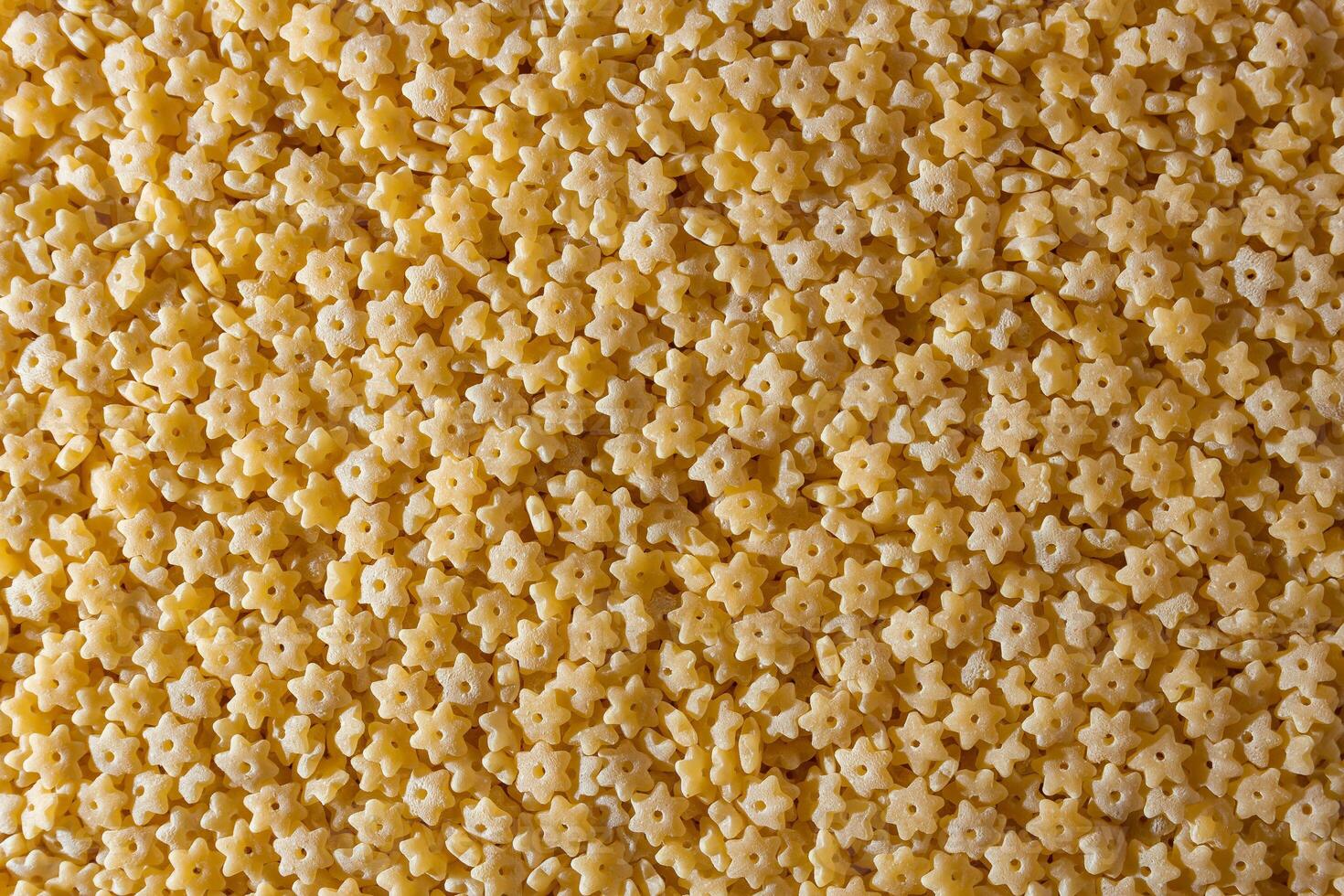 Uncooked Stelline Pasta. A Culinary Canvas of Stelline Macaroni, Creating a Lively and Textured Background for Gourmet Cooking. Dry Pasta. Raw Macaroni - Top View, Flat Lay photo