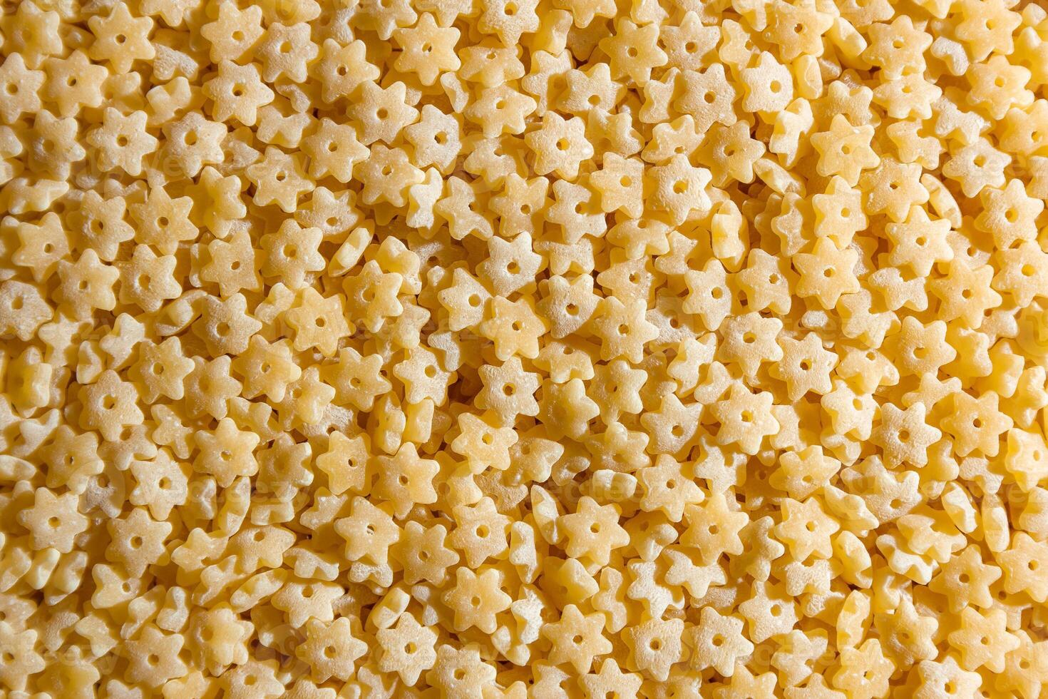 Uncooked Stelline Pasta. A Culinary Canvas of Stelline Macaroni, Creating a Lively and Textured Background for Gourmet Cooking. Dry Pasta. Raw Macaroni - Top View, Flat Lay photo