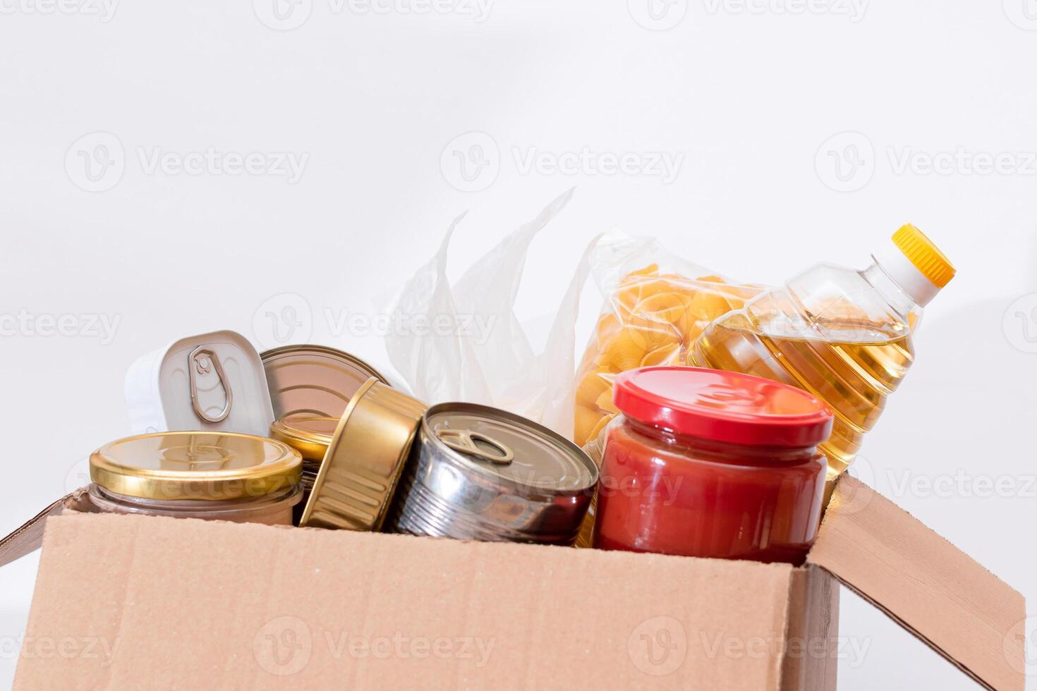 Donation Box of Free Food. Carton Box with Canned Food, Cereals and Grocery. Meal Reserves. Emergency Food Storage in Case of Crisis. Free Social Help, Blessings and Care. Strategic Food Supplies photo