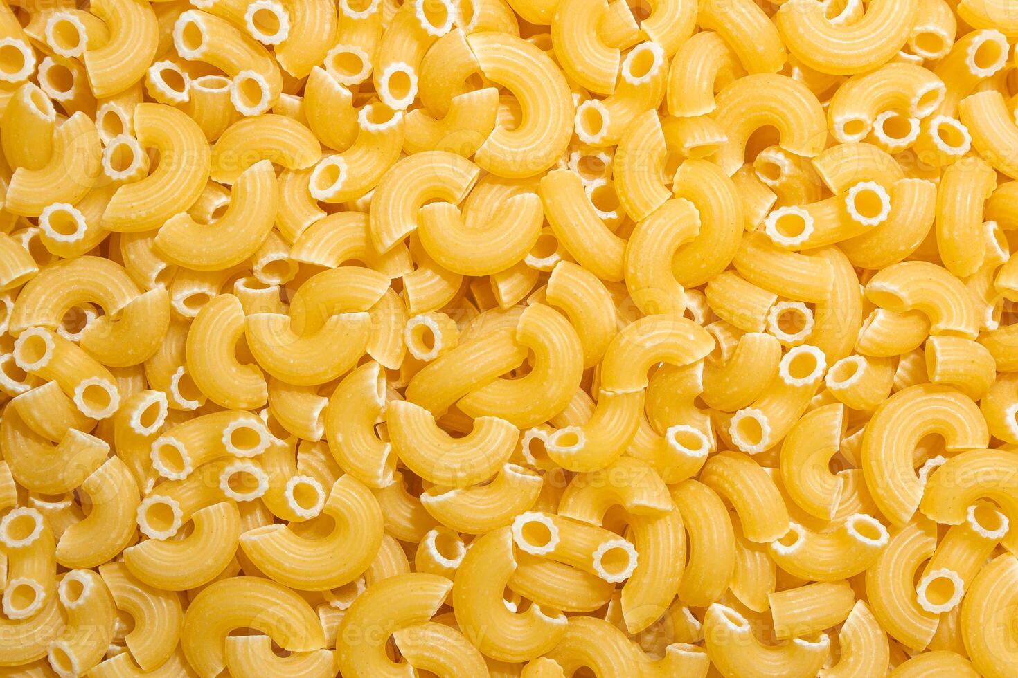 Uncooked Chifferi Rigati Pasta. A Culinary Canvas of Chifferi Rigati, Creating a Lively and Textured Background for Gourmet Cooking. Dry Pasta. Raw Macaroni - Top View, Flat Lay photo