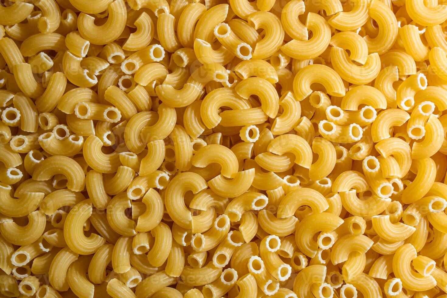 Uncooked Chifferi Rigati Pasta. A Culinary Canvas of Chifferi Rigati, Creating a Lively and Textured Background for Gourmet Cooking. Dry Pasta. Raw Macaroni - Top View, Flat Lay photo
