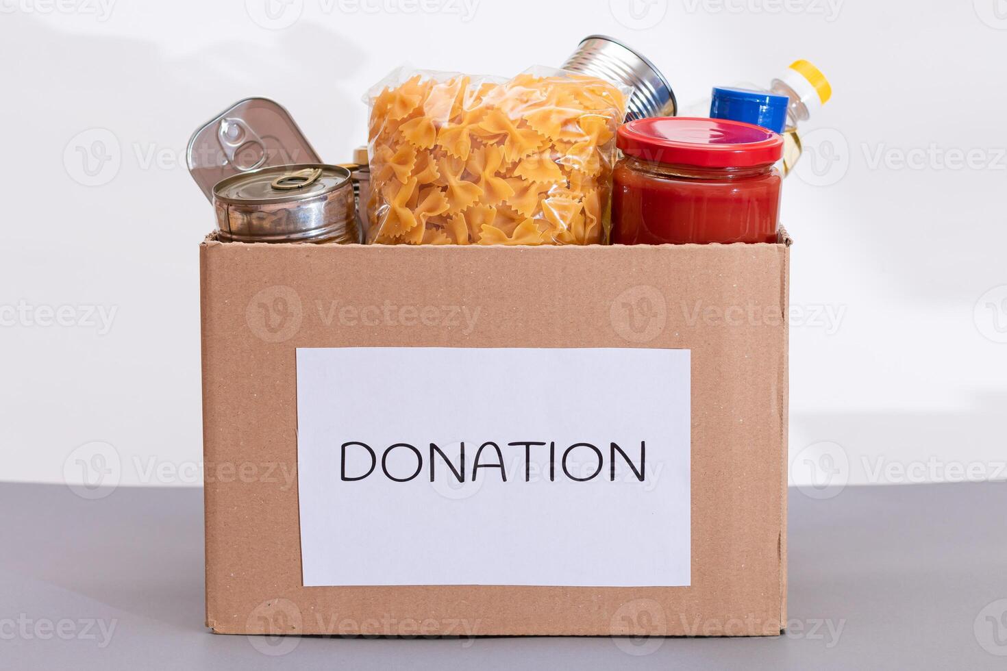 Donation Box of Free Food. Carton Box with Canned Food, Cereals and Grocery. Meal Reserves. Emergency Food Storage in Case of Crisis. Free Social Help, Blessings and Care. Strategic Food Supplies photo