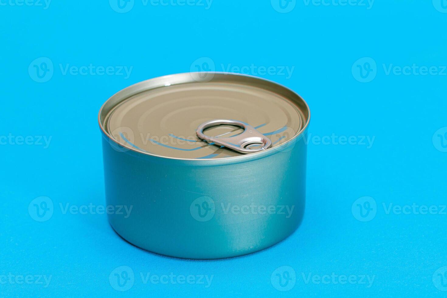 Unopened Tin Can with Blank Edge on Light Blue Background. Canned Food. Aluminum Can for Safe and Long Term Storage of Food. Steel Sealed Food Storage Container photo
