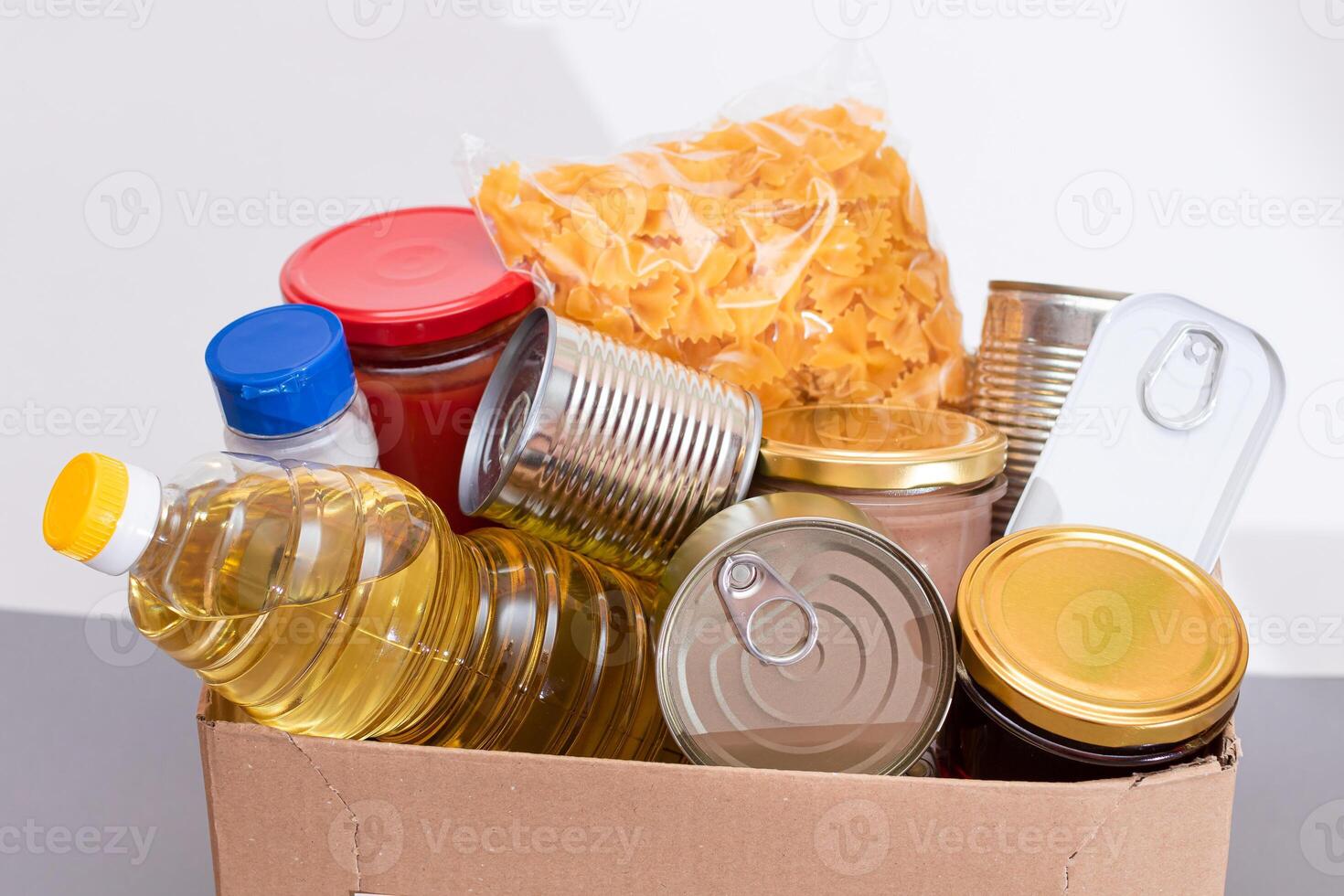 Donation Box of Free Food. Carton Box with Canned Food, Cereals and Grocery. Meal Reserves. Emergency Food Storage in Case of Crisis. Free Social Help, Blessings and Care. Strategic Food Supplies photo