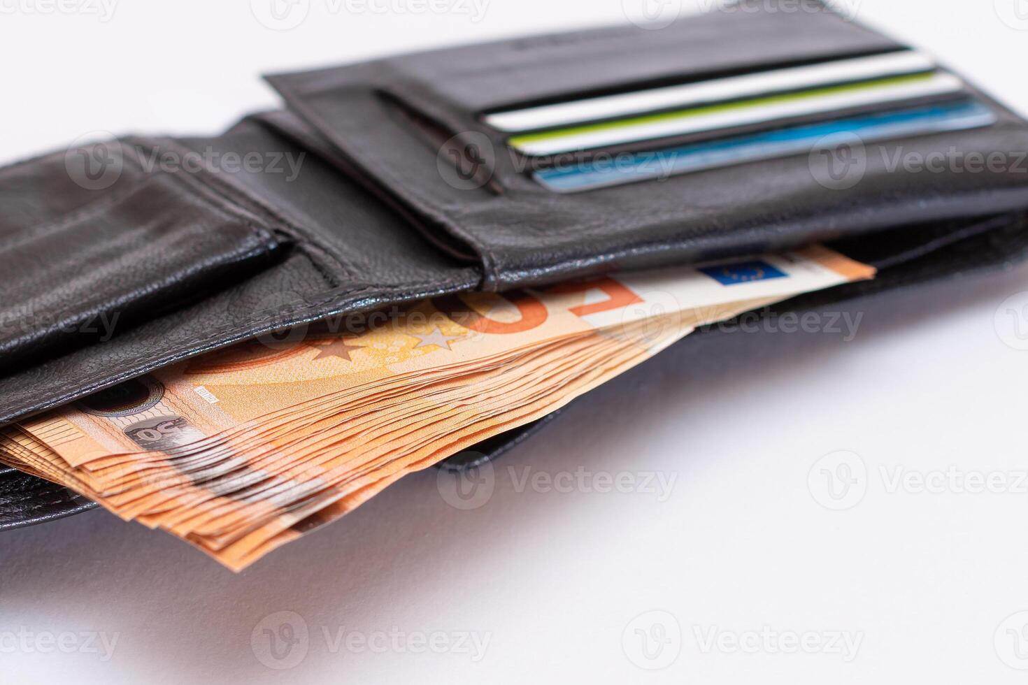 Opened Black Leather Men Wallet with Fifty Euro Banknotes and Bank Cards Inside on White Background. A Purse Full of Money and Credit Cards Symbolizing Wealth, Success and Social Status photo