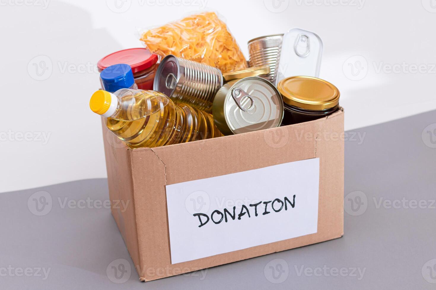 Donation Box of Free Food. Carton Box with Canned Food, Cereals and Grocery. Meal Reserves. Emergency Food Storage in Case of Crisis. Free Social Help, Blessings and Care. Strategic Food Supplies photo