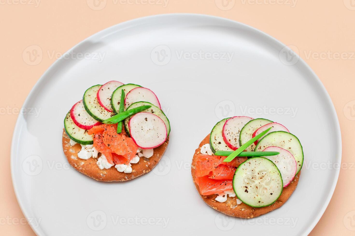 Crispy Cracker Sandwiches with Fresh Salmon, Cucumber, Radish, Cottage Cheese and Green Onions. Easy Breakfast. Quick and Healthy Sandwiches. Crispbread with Tasty Filling. Healthy Dietary Snack photo