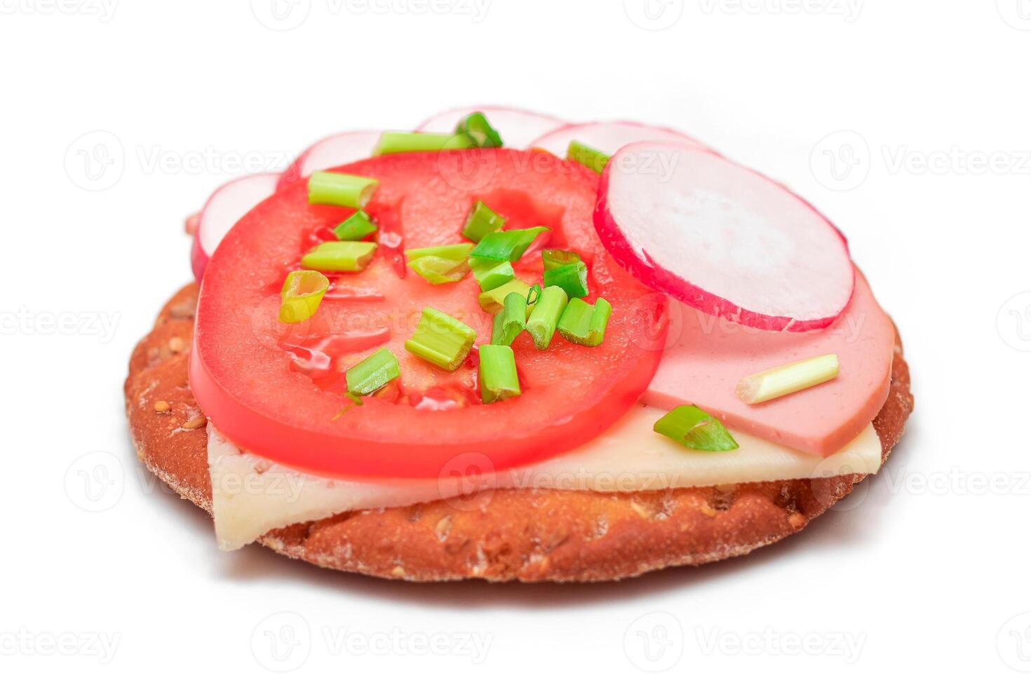 Crispy Cracker Sandwich with Tomato, Sausage, Cheese, Green Onions and Radish - Isolated on White. Easy Breakfast. Diet Food. Quick and Healthy Sandwiches. Crispbread with Tasty Filling - Isolation photo