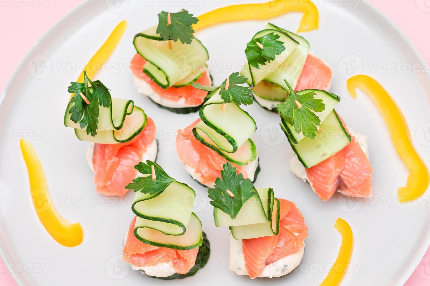 Canapes without Bread with Fresh Salmon, Cucumber and Cream Cheese on White Plate. Easy Breakfast. Diet Food. Quick and Healthy Sandwiches. Healthy Snacks with Tasty Fillings photo
