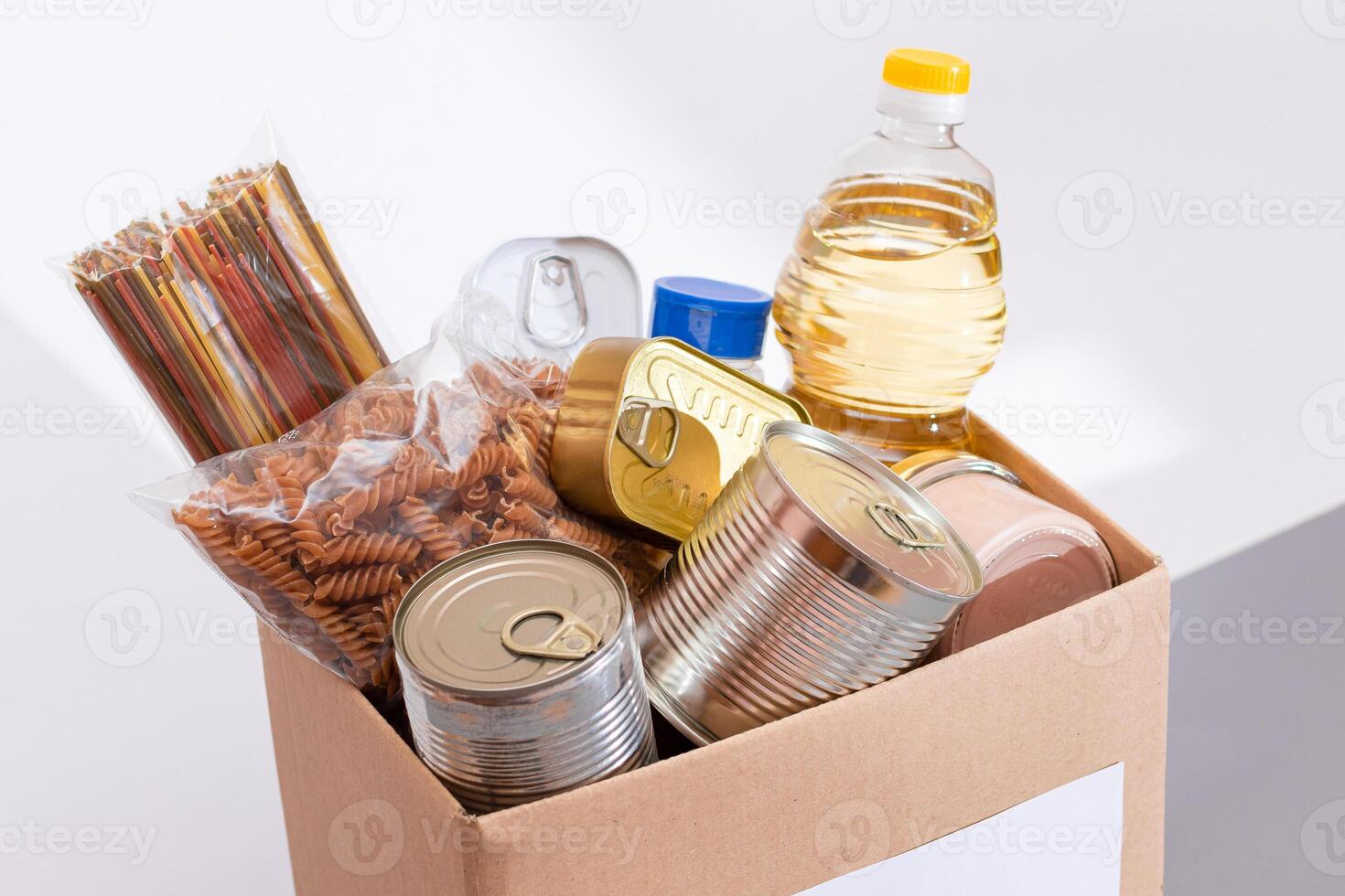 Donation Box of Free Food. Carton Box with Canned Food, Cereals and Grocery. Meal Reserves. Emergency Food Storage in Case of Crisis. Free Social Help, Blessings and Care. Strategic Food Supplies photo