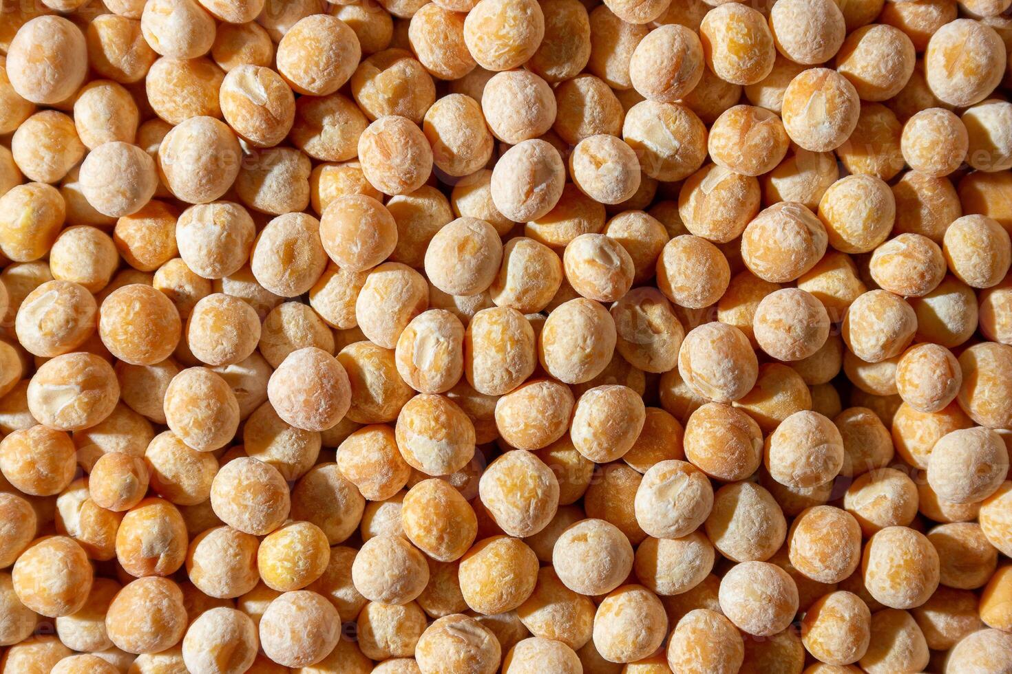 Uncooked Yellow Polished Peas Background. A Culinary Canvas of Dry Yellow Peas, Creating a Lively and Textured Background for Gourmet Cooking. Scattered Raw Polished Peas. Healthy Eating Ingredients photo