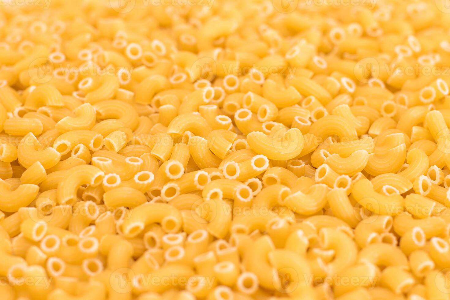 Uncooked Chifferi Rigati Pasta Background. Fat and Unhealthy Food. Classic Dry Macaroni Texture. Italian Culture and Cuisine. Raw Pasta photo
