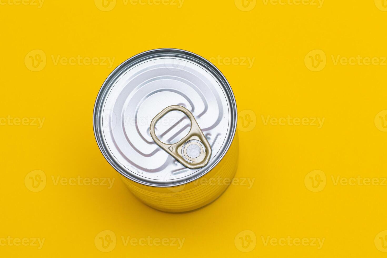 Unopened Tin Can with Blank Edge on Yellow Background. Canned Food. Aluminum Can for Safe and Long Term Storage of Food. Steel Sealed Food Storage Container photo