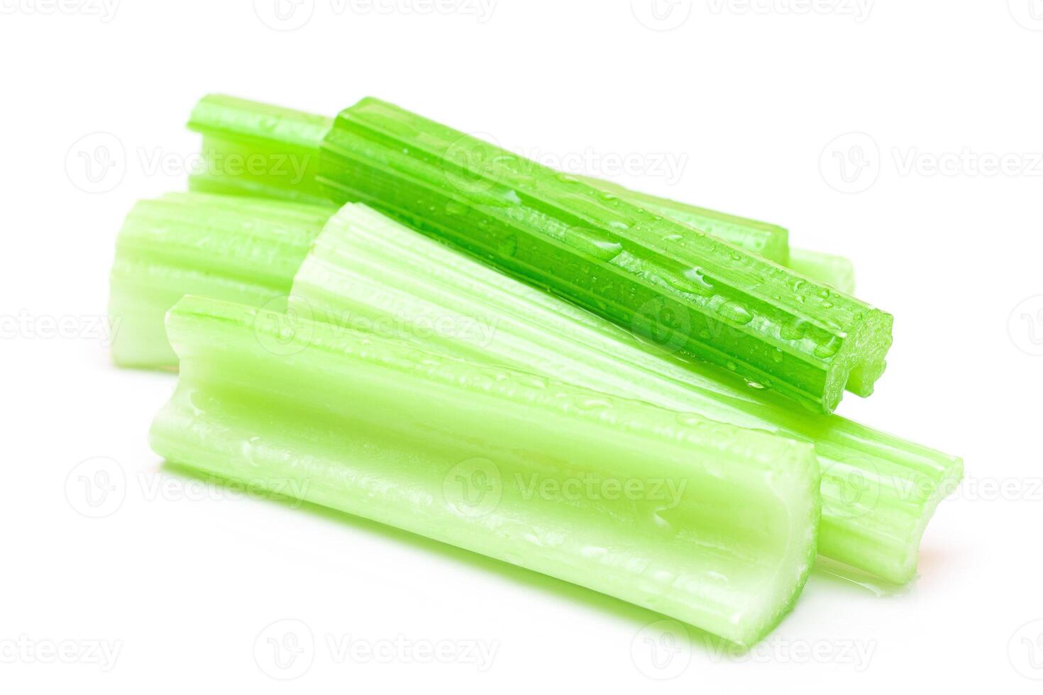 Fresh Chopped Celery Sticks with Water Drops Isolated on White Background. Vegan and Vegetarian Culture. Raw Food. Healthy Diet with Negative Calorie Content photo