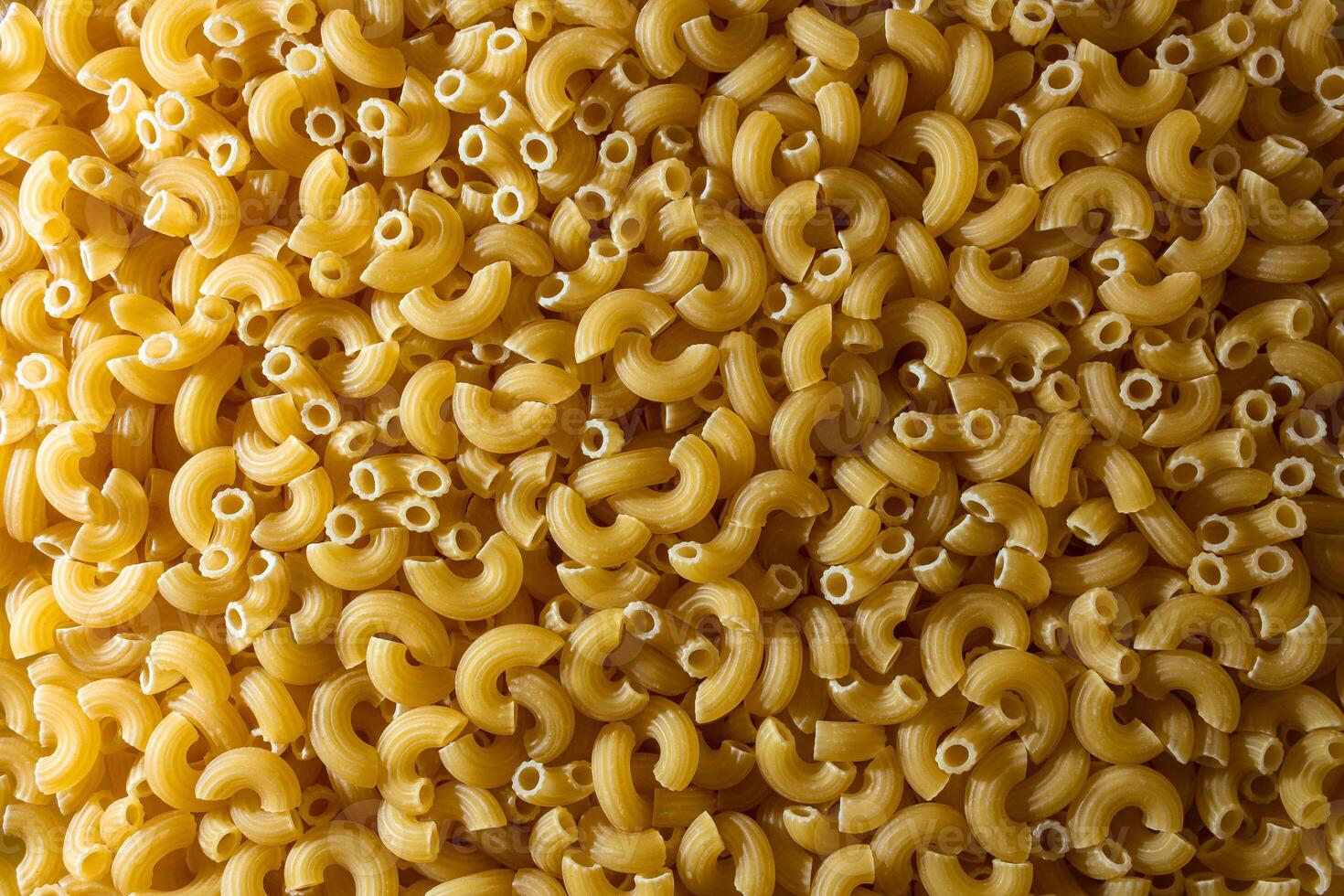 Uncooked Chifferi Rigati Pasta. A Culinary Canvas of Chifferi Rigati, Creating a Lively and Textured Background for Gourmet Cooking. Dry Pasta. Raw Macaroni - Top View, Flat Lay photo