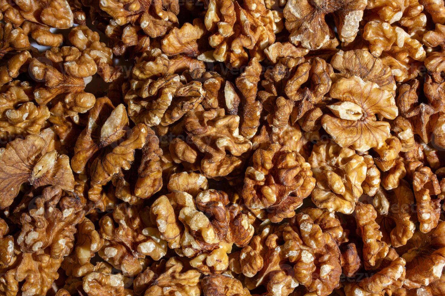 Scattered Shelled Walnuts. Background from Walnut. Natural High-Calorie Snacks photo