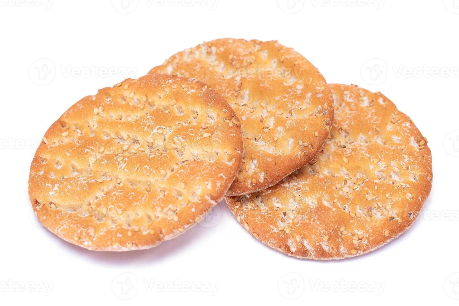 A Heap of Round Salt Crackers with Sesame Isolated on White Background. Dry Snacks - Isolation photo