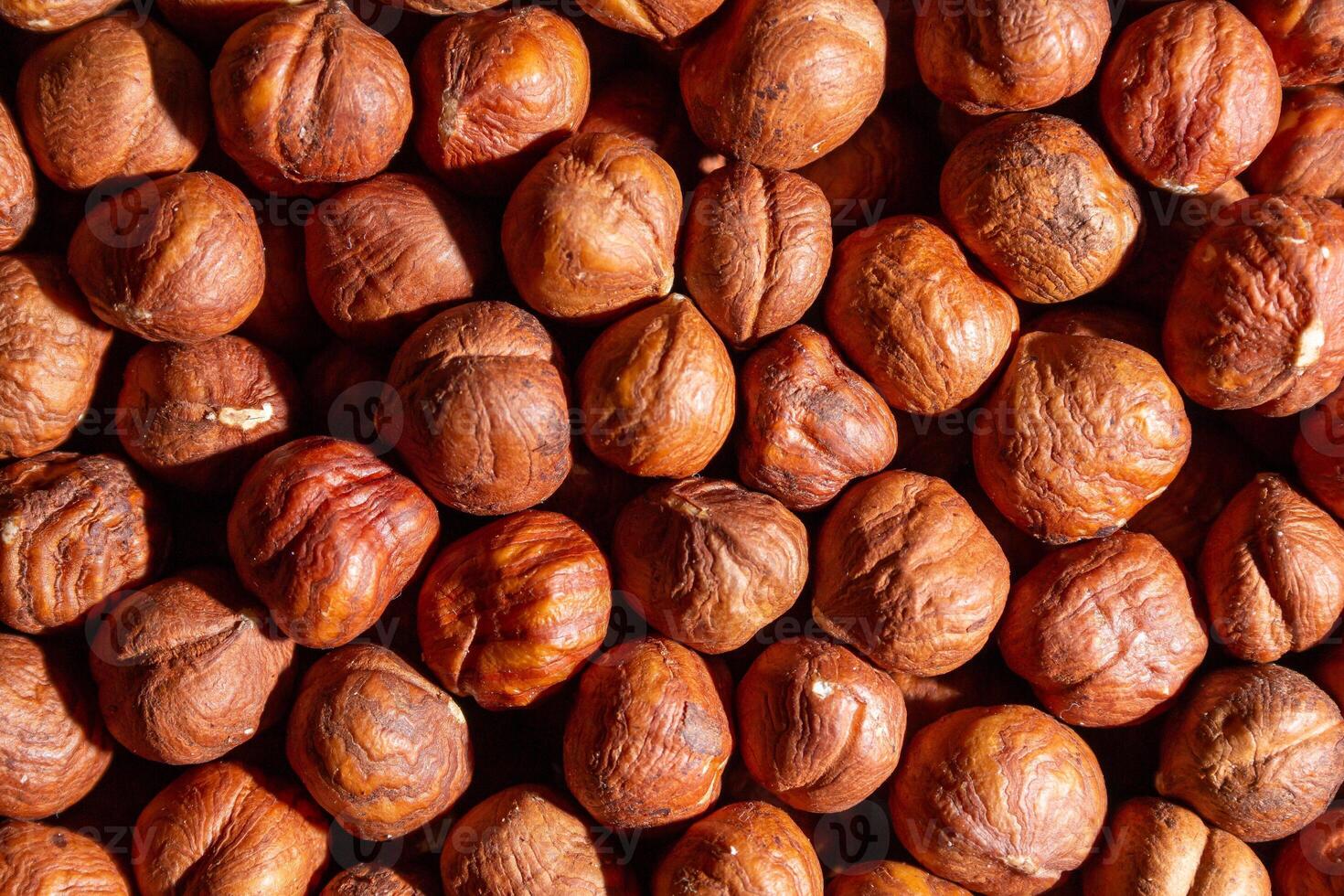 Scattered Peeled Hazelnut - Top View. Background from Hazelnuts. Natural High-Calorie Snacks photo