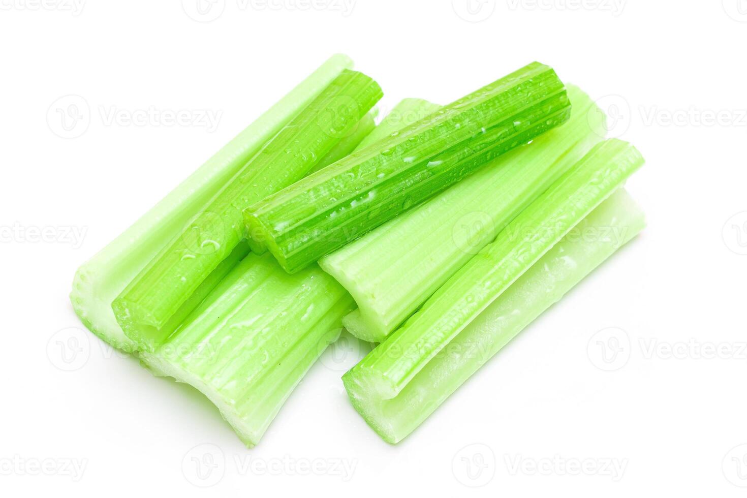 Fresh Chopped Celery Sticks with Water Drops Isolated on White Background. Vegan and Vegetarian Culture. Raw Food. Healthy Diet with Negative Calorie Content photo