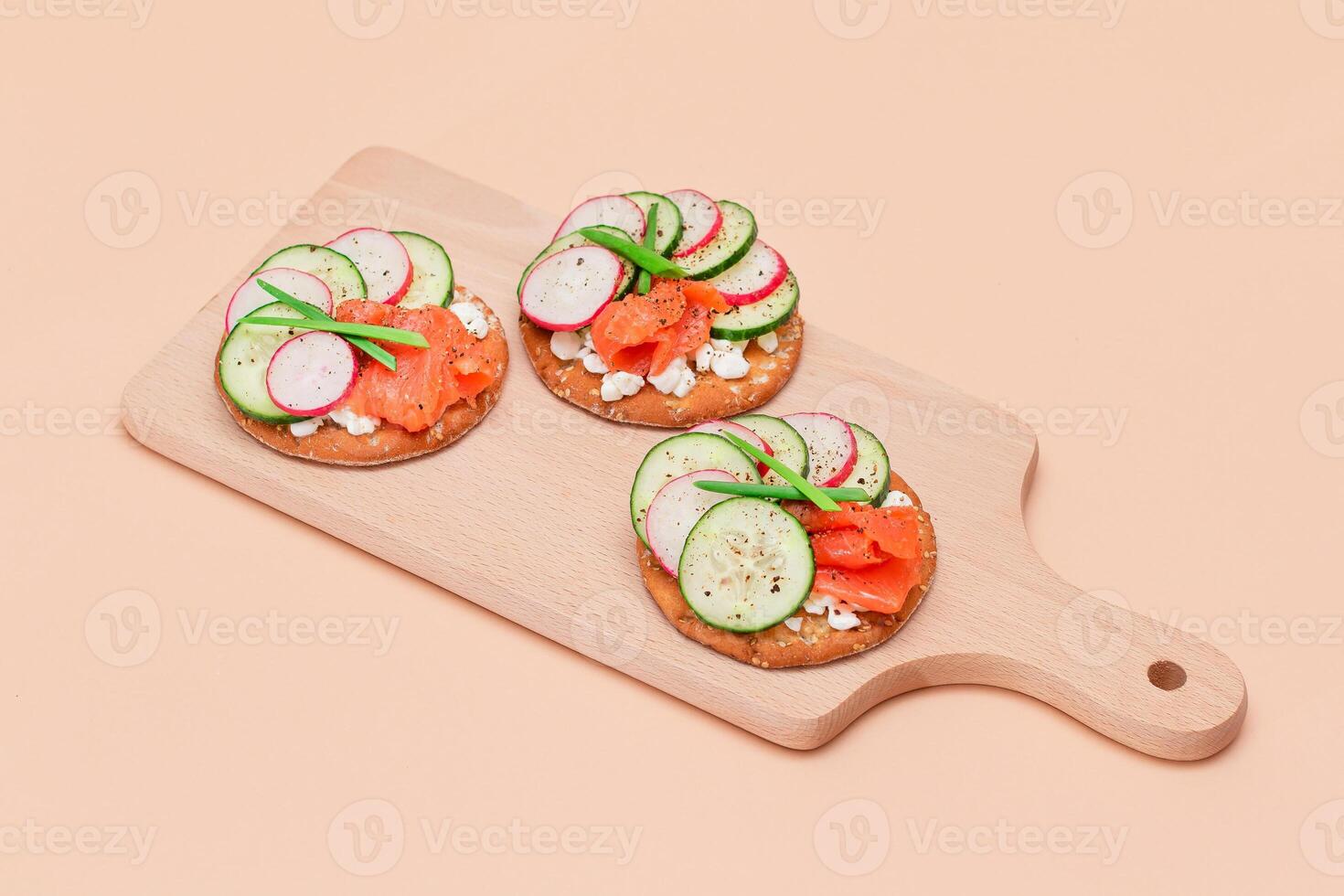 Crispy Cracker Sandwiches with Fresh Salmon, Cucumber, Radish, Cottage Cheese and Green Onions. Easy Breakfast. Quick and Healthy Sandwiches. Crispbread with Tasty Filling. Healthy Dietary Snack photo