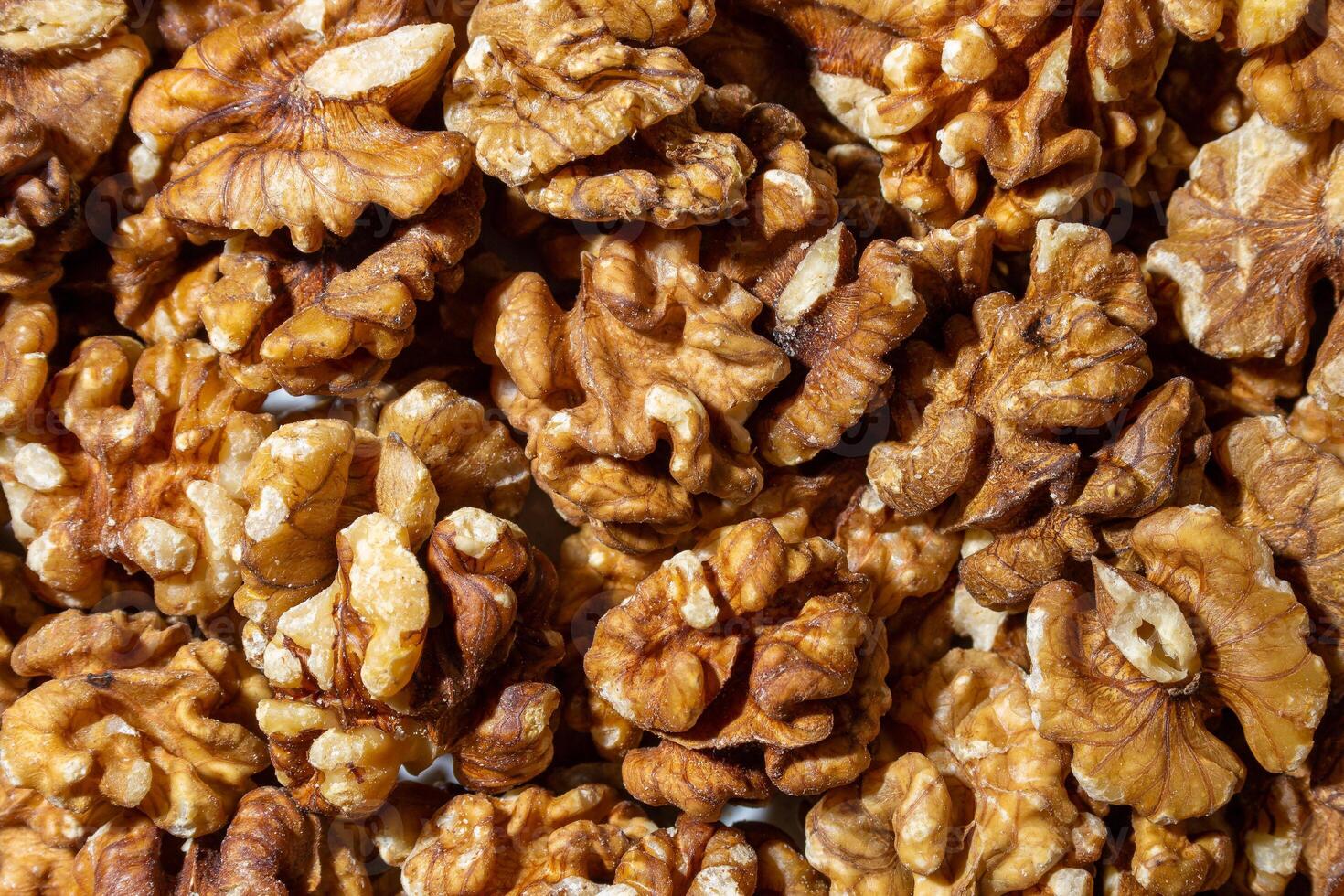Scattered Shelled Walnuts. Background from Walnut. Natural High-Calorie Snacks photo