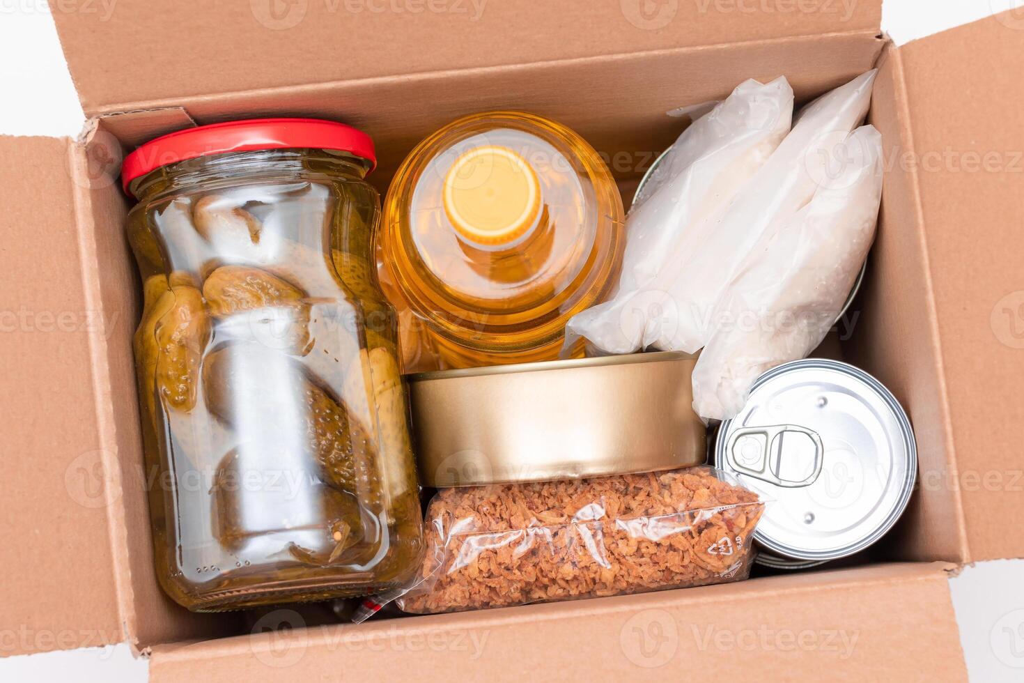 Food Reserves or Donation Box. Carton Box with Canned Food, Cereals and Grocery. Emergency Food Storage in Case of Crisis. Free Social Help, Blessings and Care. Strategic Food Supplies photo