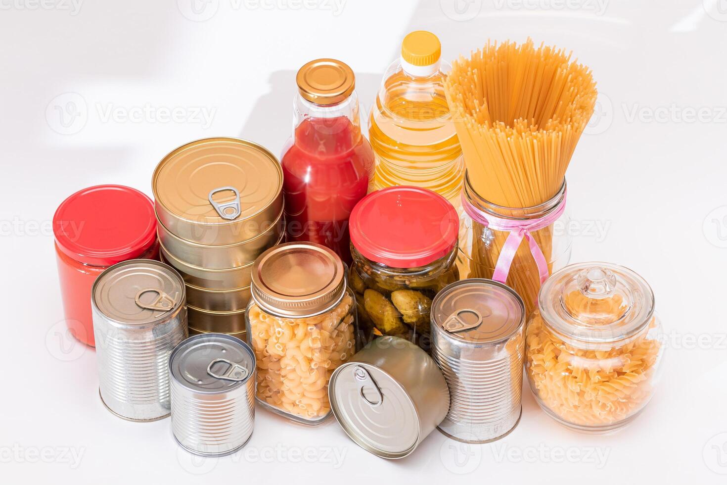 Food Reserves. Canned Food, Spaghetti, Pate, Tuna, Tomato Juice, Pasta, Fish and Grocery on White Background. Emergency Food Storage in Case of Crisis. Strategic Food Supplies photo