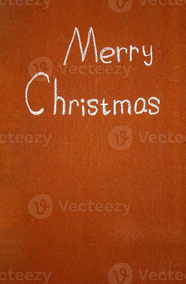 Merry Christmas written by hand with chalk, on an abstract background photo